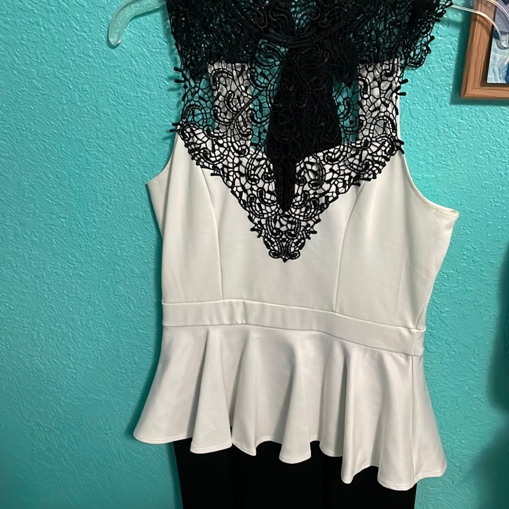 White and black mini dress with black lace along the neckline.